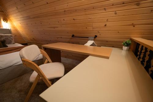 a small room with a desk and a bed at Timber Haven Aframe Cabin - Brand New Hot Tub in Friendship