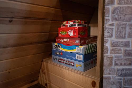 a stack of books stacked on top of each other at Timber Haven Aframe Cabin - Brand New Hot Tub in Friendship