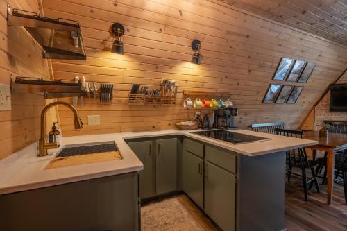 a kitchen with a sink and a counter top at Timber Haven Aframe Cabin - Brand New Hot Tub in Friendship