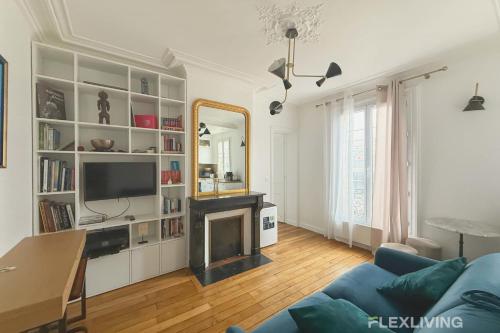 un salon avec une cheminée et un miroir dans l'établissement Flexliving - T2 - Eugène Gibez, à Paris