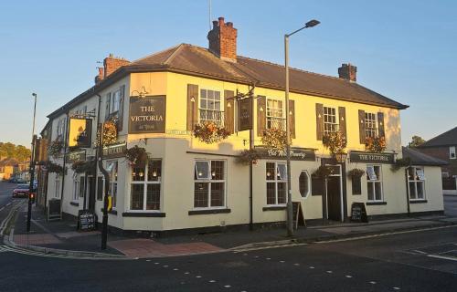 a yellow building on the corner of a street at The Victoria Hotel in York