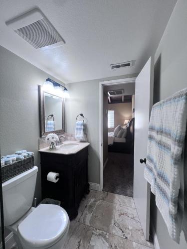 a bathroom with a sink and a toilet and a mirror at Destination #20 in Anaheim
