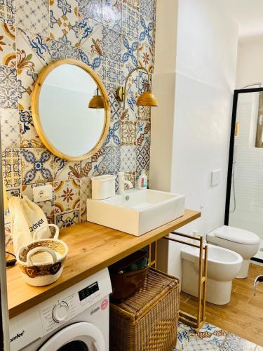 a bathroom with a sink and a washing machine at Casa Giua in Campese