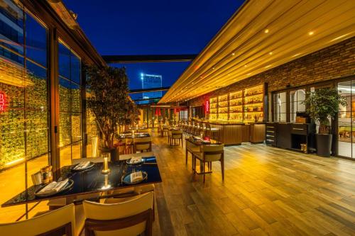 a restaurant with tables and chairs in a building at Holiday Inn Ankara - Cukurambar by IHG in Ankara