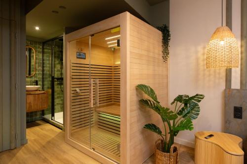 a bathroom with a shower with a plant in it at Suite romantique Bali, Sauna , Spa in Strasbourg