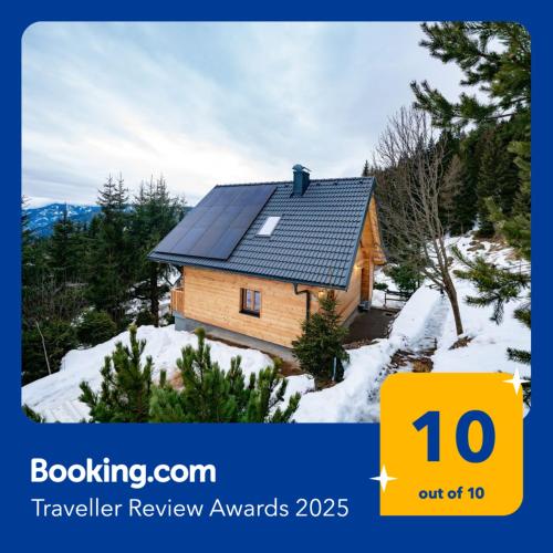 a house with solar panels on it in the snow at ALMNEST - LACHTAL in Lachtal