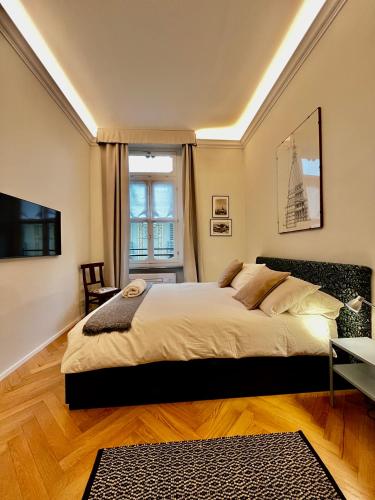 a bedroom with a large bed and a window at Suite Florio in Turin