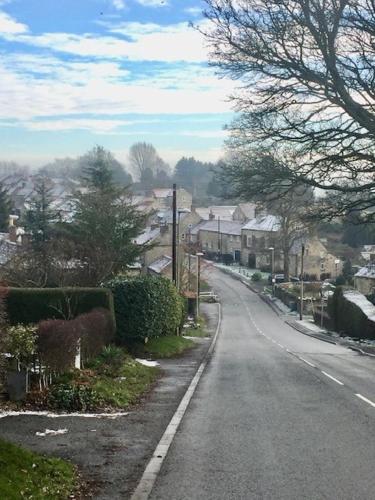 an empty street in a residential neighborhood with houses at Bulldog Cottage in Ampleforth