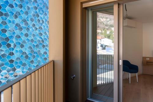 a glass mosaic on the side of a house at Serviced Apartments by Hotel de Charme Laveno in Laveno