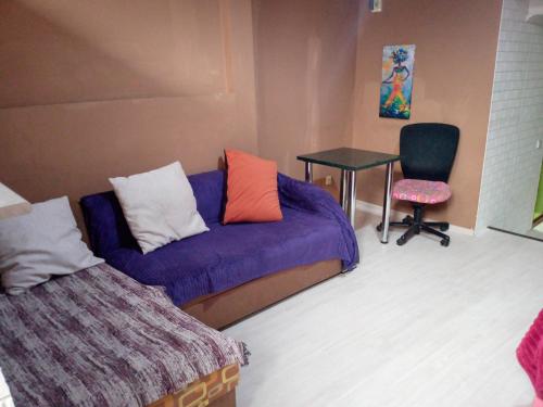 a room with a couch and a table and a chair at birdhome in Tbilisi (Maria) in Tbilisi City