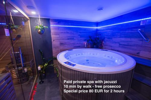 a large tub in a bathroom with blue lights at Sauna studio near centre/airport in Prague