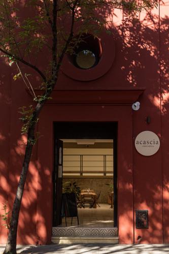 a red building with a doorway with a table in it at El Consuelo in Oaxaca City