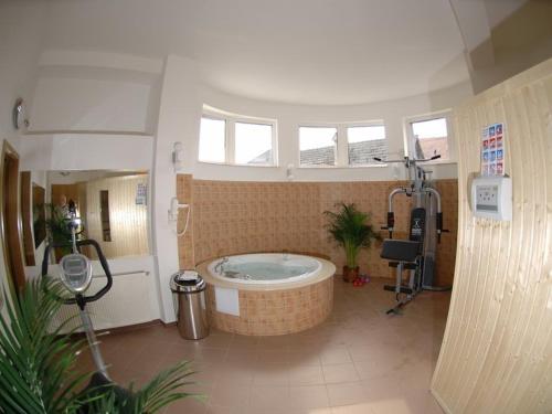 a large bathroom with a tub in the middle at Hotel Oasis in Braşov