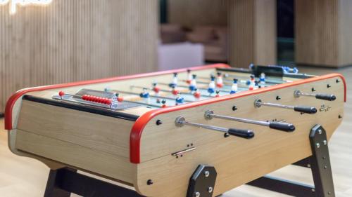 a wooden foosball table with balls on it at Hotel Nido Príncipe Pío in Madrid