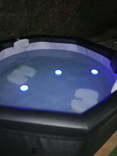 a blue poker table with lights on top of it at NOUVEAUTE Maison Cocooning avec jardin, Terrasse couverte et Jacuzzi in Bellerive-sur-Allier