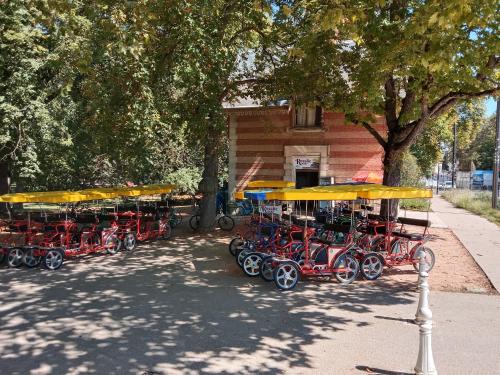 a group of red carts parked in front of a building at NOUVEAUTE Maison Cocooning avec jardin, Terrasse couverte et Jacuzzi in Bellerive-sur-Allier