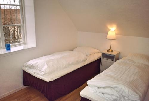 A bed or beds in a room at Dragør Hotel & Apartments