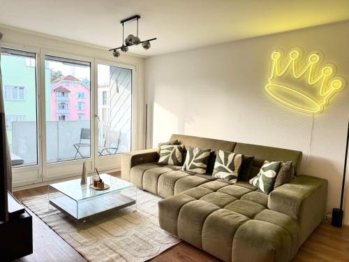 a living room with a couch and a large window at Modern & Central Apartment - Zurich Oerlikon in Zürich