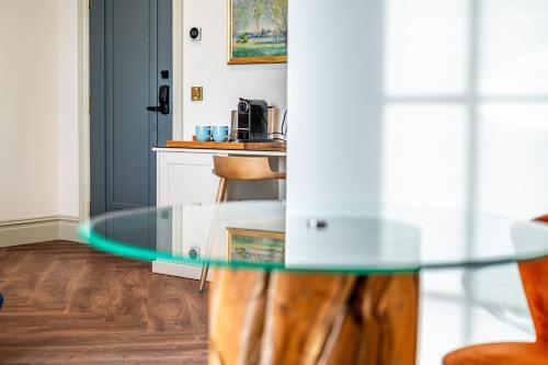 a glass table in a room with a kitchen at St Marys Quarters in Nottingham