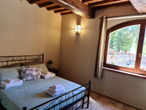 En eller flere senge i et værelse på Agriturismo Il Bagnano