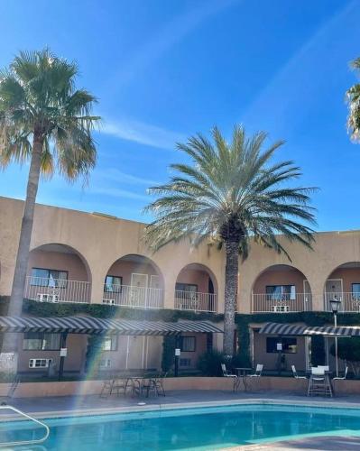 a hotel with palm trees and a swimming pool at Hotel Santa Fe in Camargo
