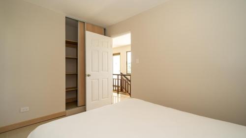 a bedroom with a bed and a closet at Breeze and Sunset at Playa Hermosa in Playa Hermosa