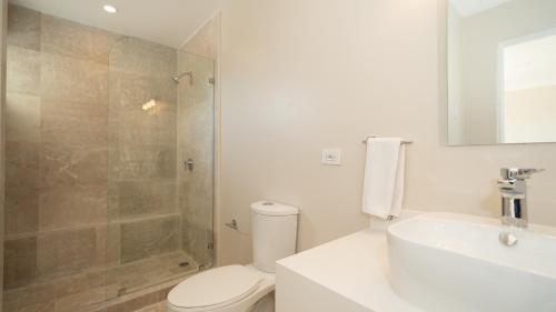 a bathroom with a shower and a toilet and a sink at Breeze and Sunset at Playa Hermosa in Playa Hermosa