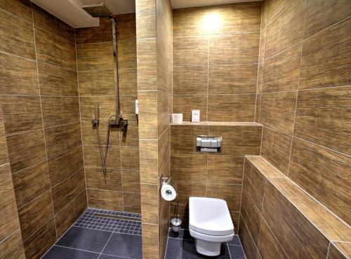 a bathroom with a toilet and a shower at Hotel Pieris in Vysoke Tatry - Podbanske