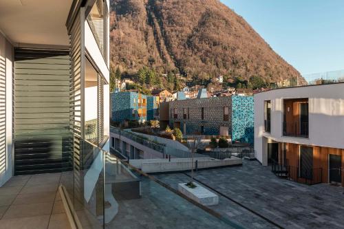 a view from the balcony of a building with a mountain in the background at Serviced Apartments by Hotel de Charme Laveno in Laveno