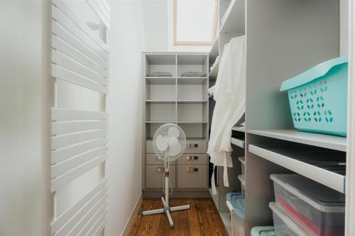 a walk in closet with a floor fan in it at Villa La Côte du Chat in Hédé