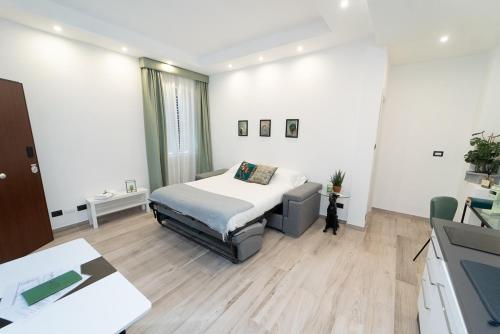 a bedroom with a bed and a couch in it at Maison Salvia in Rome