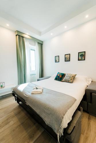 a bedroom with a large bed and a window at Maison Salvia in Rome