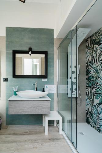 a bathroom with a tub and a sink and a mirror at Maison Salvia in Rome