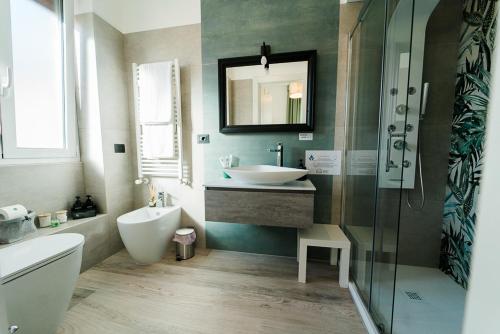 a bathroom with a sink and a toilet and a mirror at Maison Salvia in Rome