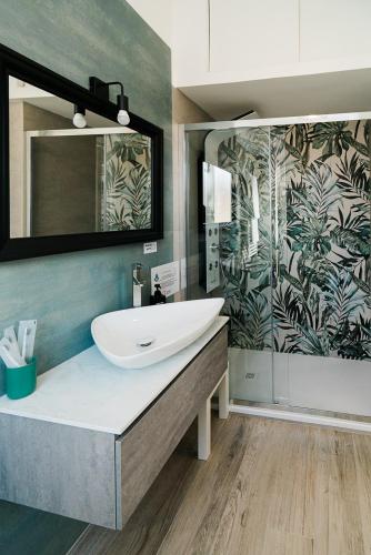a bathroom with a sink and a large mirror at Maison Salvia in Rome