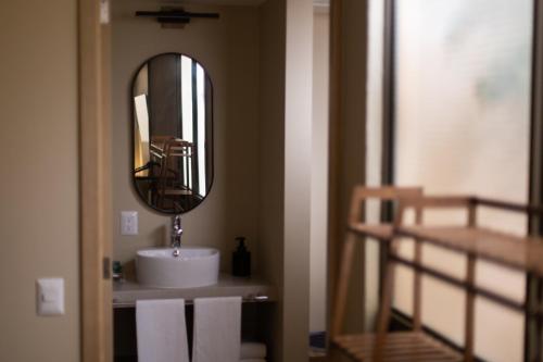 a bathroom with a sink and a mirror at El Consuelo in Oaxaca City