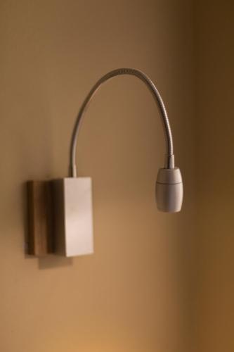 a light hanging on a wall with at El Consuelo in Oaxaca City