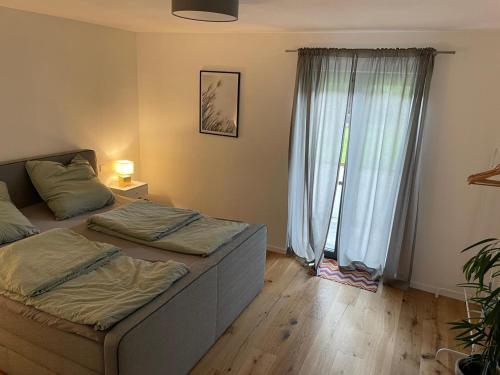 a bedroom with two beds and a window at Fewo Matzing - beim Gartner in Matzing