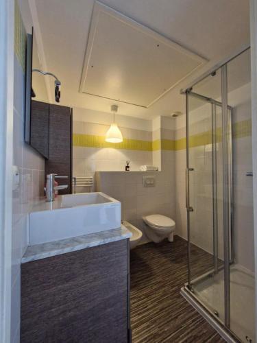 une salle de bain avec un lavabo, une douche et des toilettes dans l'établissement Les Jardins de Monaco, à Cap d'Ail