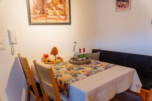 a dining room table with a tablecloth on a table with chairs at Collenberger Ferienwohnung Schäfer in Reistenhausen