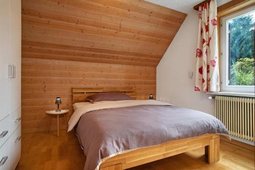a bedroom with wooden walls and a large bed at Casa Orazio Haus In Bregenz in Bregenz
