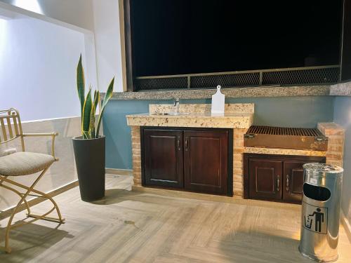 a bathroom with a sink and a chair in a room at San Francisco Luxury Prestige 1 in Juticalpa