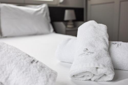 a hotel room with a towel on a bed at Thessaloniki Central Apartment 2 in Thessaloniki