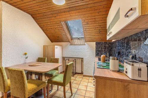 a kitchen and dining room with a table and chairs at Azalea in Olsberg