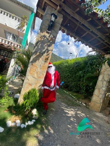 a santa claus statue standing under a bridge at HOTEL VILLA CAMPESTRE AVENTUREROS in San Gil