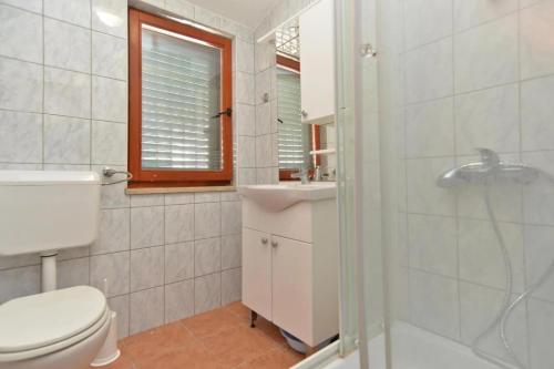a bathroom with a toilet and a sink and a shower at Adriatic Vacation House in Ližnjan