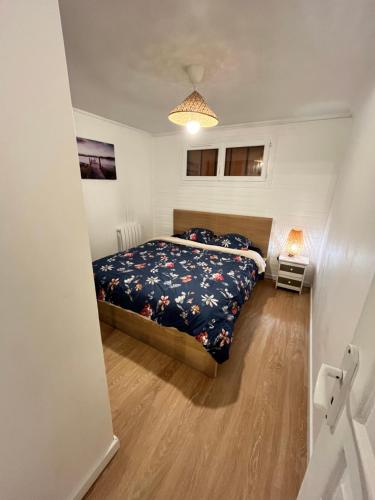 une chambre avec un lit dans une pièce blanche dans l'établissement Appartement dans petite résidence très calme, à Drancy