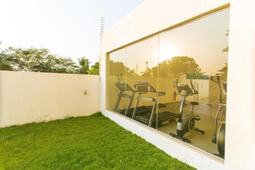 a view of a gym through a window at Accra Luxury Apartments at Lul Water in Accra