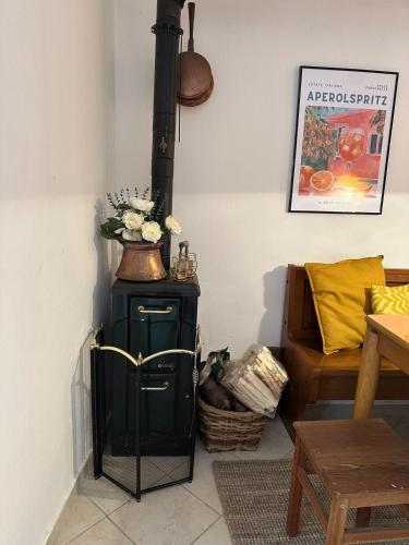 a black stove in a room with a couch at Rifugio di Rezzo in Rezzo