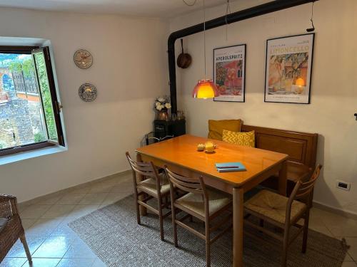 a dining room with a wooden table and chairs at Rifugio di Rezzo in Rezzo